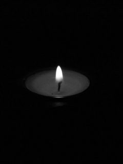 three flames of a candle on black background