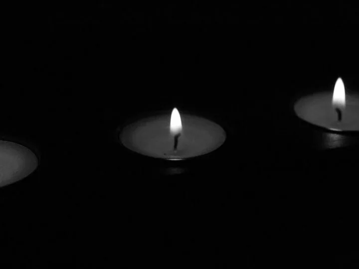 three flames of a candle on black background