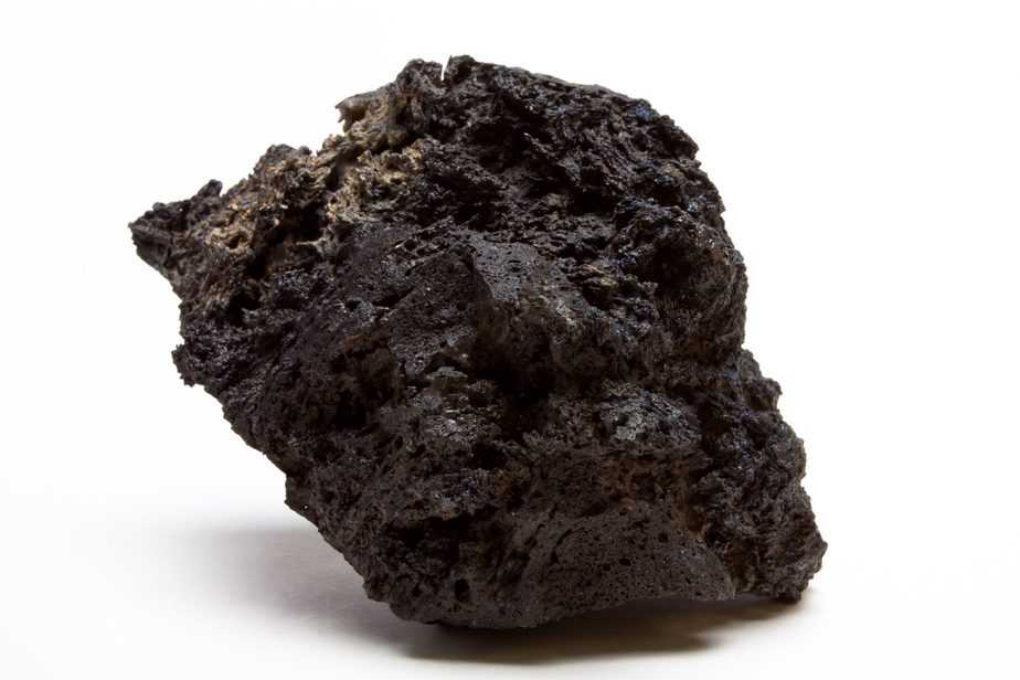 Abstract chunk of Lava Rock from low perspective isolated against white.