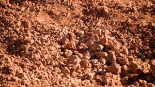 Red clay soil on nature as a background .