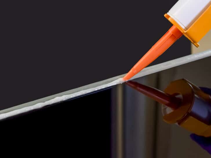 Closeup image of Applying silicone sealant by Caulking gun